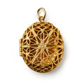 The Brass Open Work Locket is a vintage-inspired, oval brass pendant featuring an intricate floral design and a small top loop—an elegant accessory ideal for any collection.