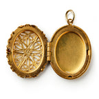 The Brass Open Work Locket features an open, oval-shaped brass design with ornate filigree on the left and a plain compartment on the right, shown against a white background—a vintage-inspired, elegant accessory.