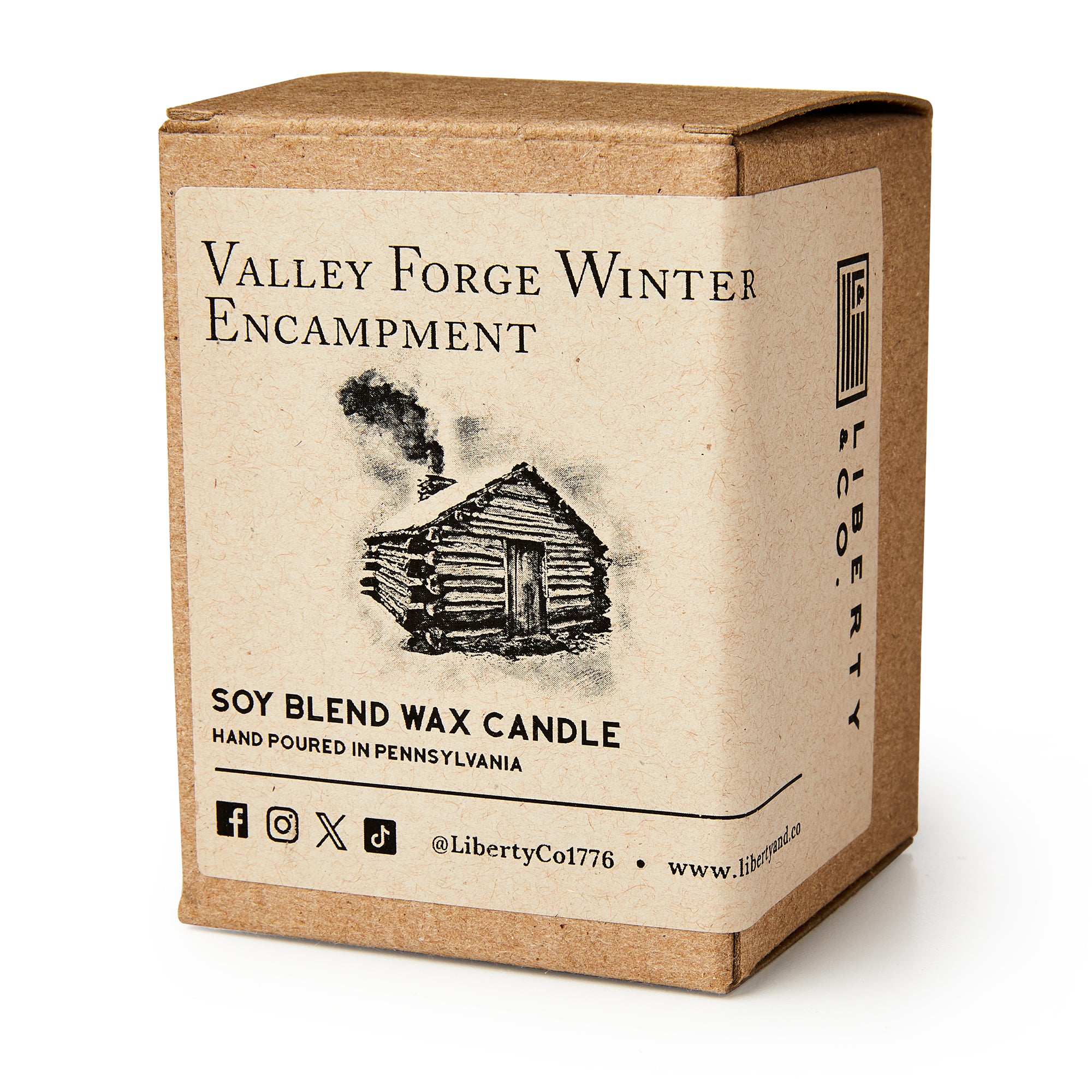 A brown box labeled Valley Forge Winter Encampment features a log cabin sketch. Inside is the Valley Forge Candle—a hand-poured soy blend by Liberty Candle Co., crafted in Pennsylvania for a warm, historical ambiance. Social media icons included.