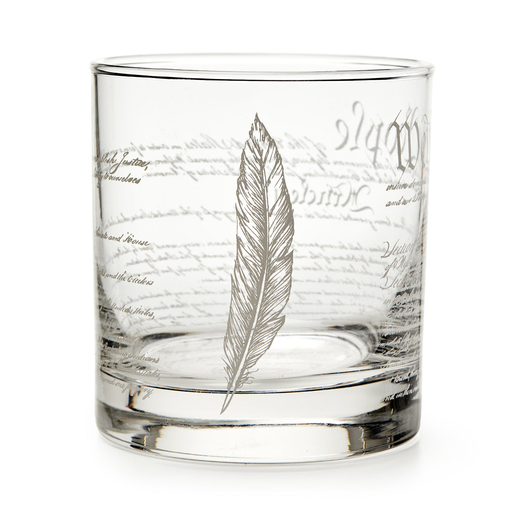 A clear glass tumbler with "We The People" etched in cursive, this Constitution whiskey glass is a thoughtful gift for history lovers and Revolutionary War enthusiasts.