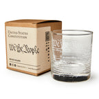 The We The People Whiskey Glass features the Constitution’s preamble elegantly etched on clear glass and comes in a brown box labeled United States Constitution by Liberty Glass Co.—a perfect gift for history buffs.