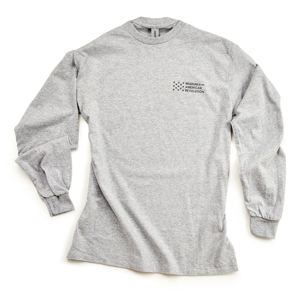 The Chain of States Long Sleeve T-Shirt is light gray with the Museum of the American Revolution logo in black on the upper left chest. It features a crew neck and ribbed cuffs—perfect for history enthusiasts.