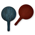 The Battledore and Shuttlecock set features two handcrafted wooden paddles, one dark blue and one reddish-brown, each with a round face and short handle, displayed against a white background.