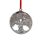 The Tree of Life Pewter Ornament is a round, handcrafted pewter piece featuring a detailed tree design and hangs from a red ribbon.