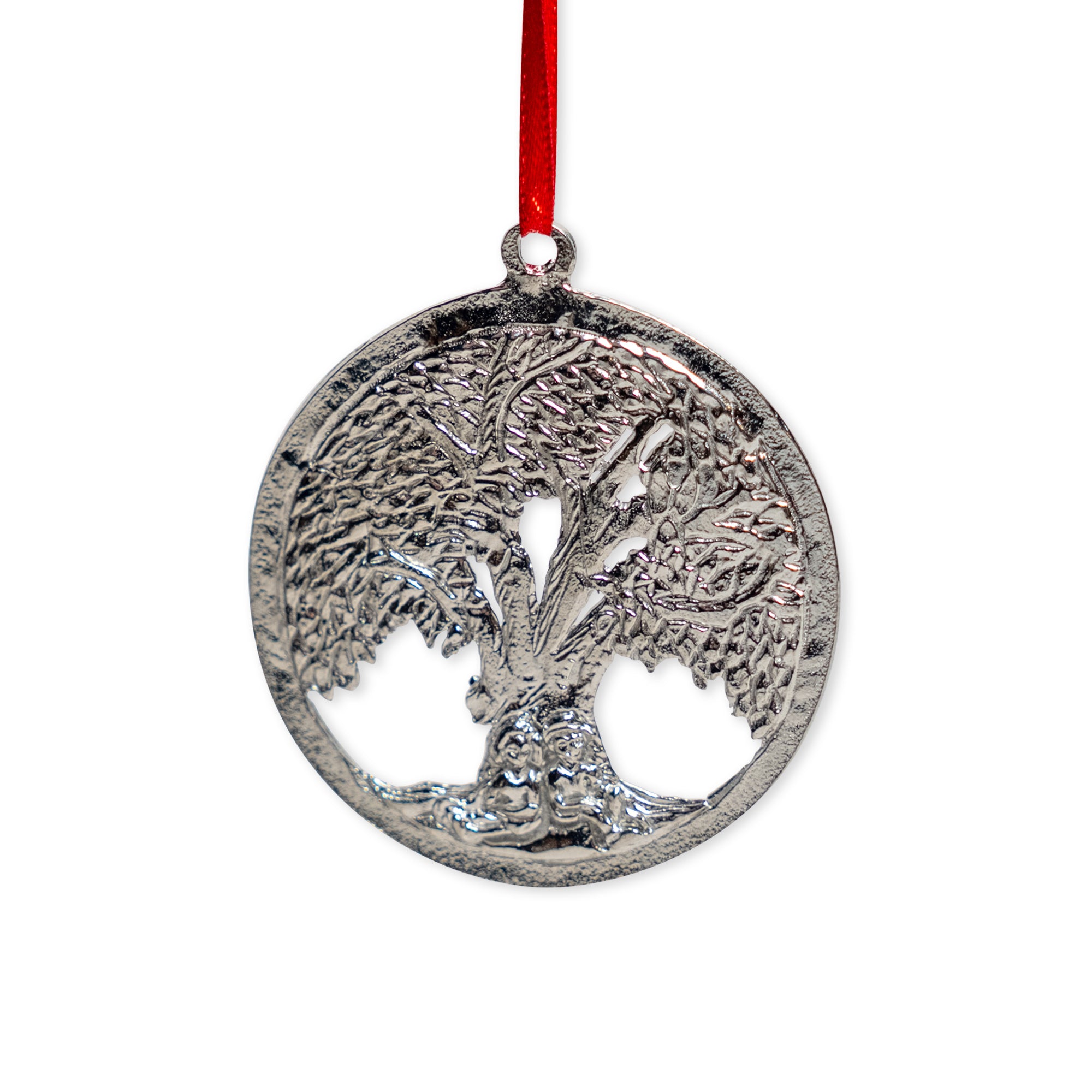 The Tree of Life Pewter Ornament is a round, handcrafted pewter piece featuring a detailed tree design and hangs from a red ribbon.