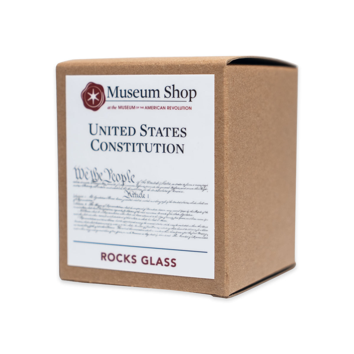 A square cardboard box for a We The People Whiskey Glass, featuring a Museum Shop logo, text from the United States Constitution preamble, and a Rocks Glass label.