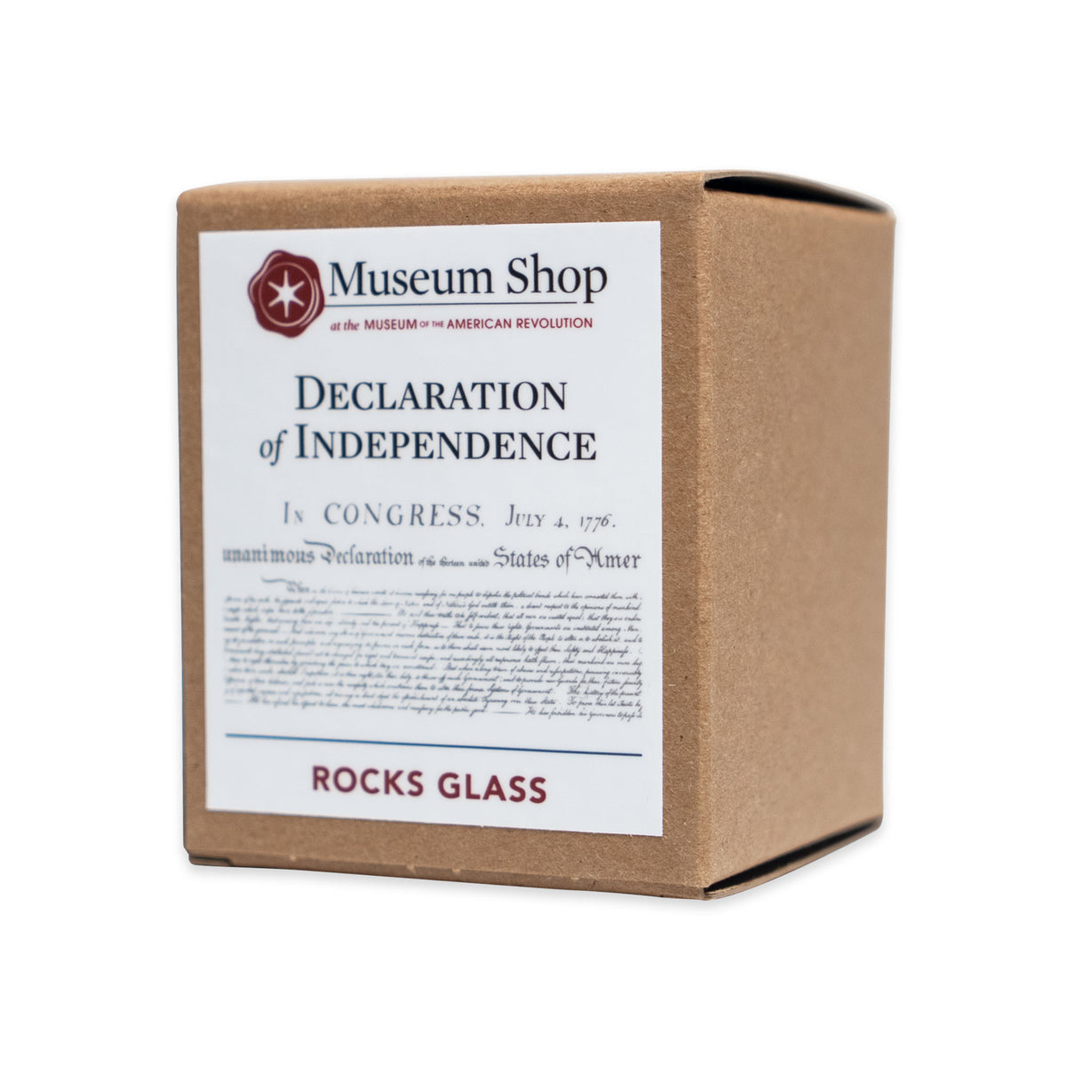 A square cardboard box for a Declaration of Independence Whiskey Glass, featuring a white label with the Museum of the American Revolution logo, the document’s text, and the words Rocks Glass.