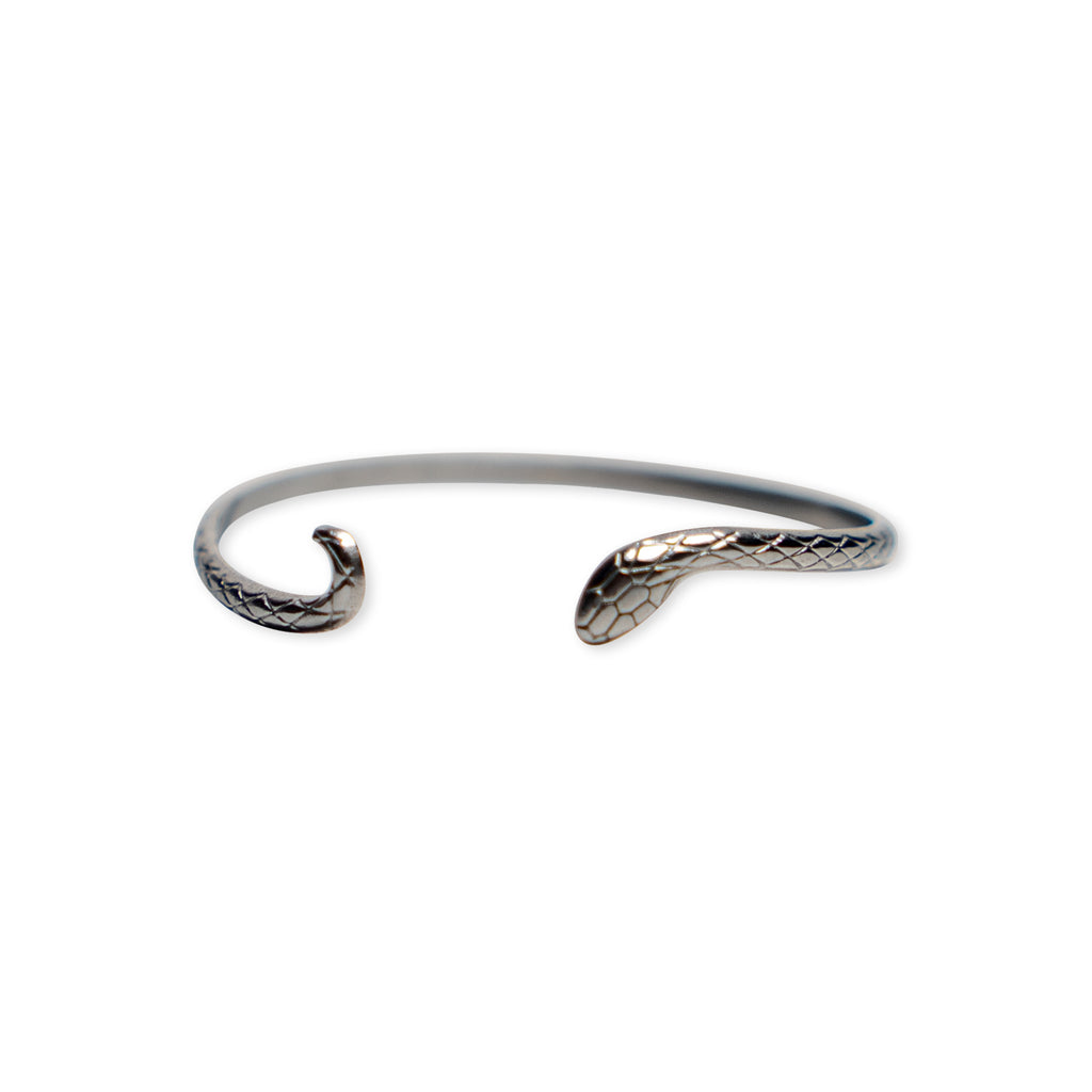 Introducing the Silver Snake Cuff Bracelet: an adjustable silver-plated piece with open ends sculpted into a snake’s head and tail, featuring finely engraved scale details for added elegance.