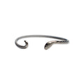Introducing the Silver Snake Cuff Bracelet: an adjustable silver-plated piece with open ends sculpted into a snake’s head and tail, featuring finely engraved scale details for added elegance.