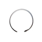 Introducing the Silver Snake Cuff Bracelet—an elegantly minimalist, silver-plated open bangle with gently flared ends, gracefully displayed on a white background. This adjustable cuff features a sculptural silhouette inspired by serpentine forms, making it the perfect accessory for effortless everyday style.