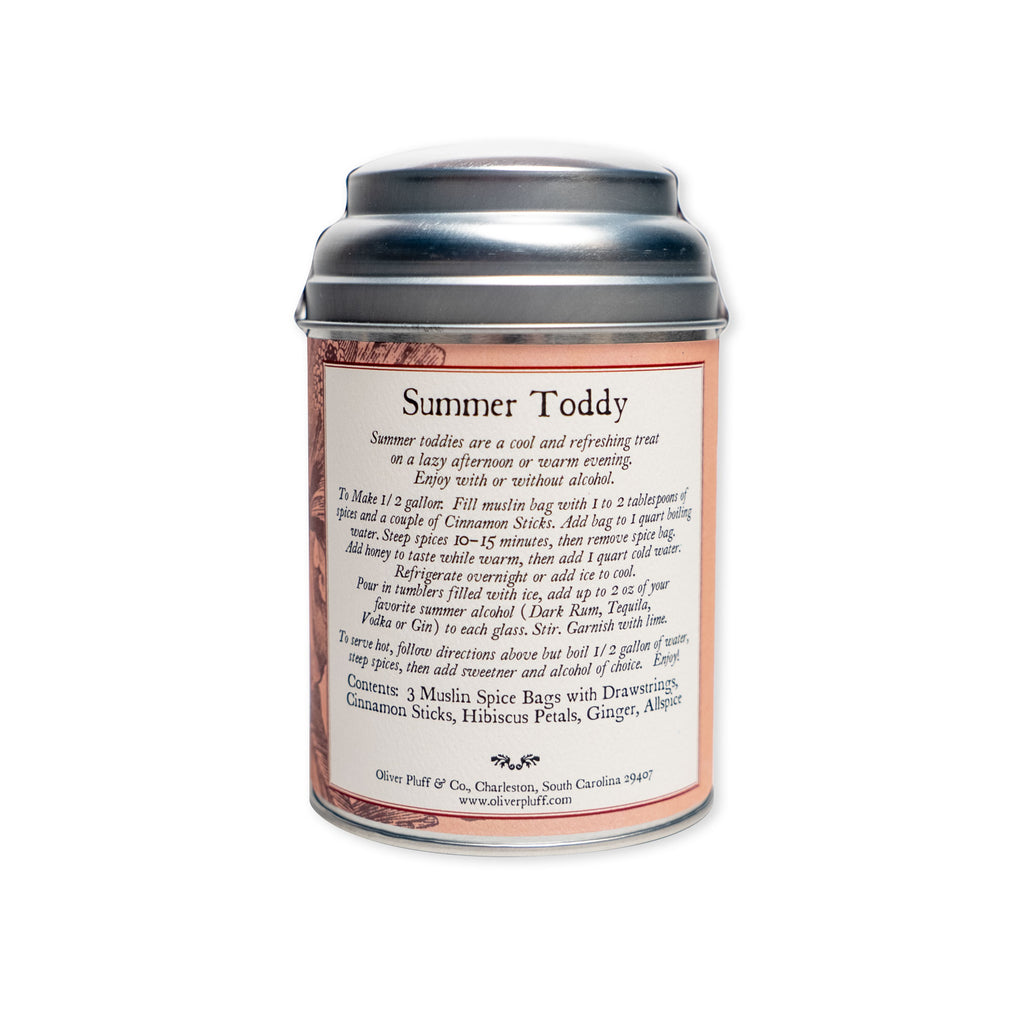 A silver tin labeled Summer Toddy, Spiced Hibiscus, complete with brewing instructions and a list of ingredients—highlighting an artisanal blend of cinnamon, hibiscus petals, ginger, and allspice—perfect for mixing into a refreshing toddy or cocktail. The tin is displayed against a plain white background.