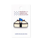 The George Washington Tent Pin: a cream-colored tent with a blue flag, displayed on carding with the Museum of the American Revolution’s logo and website—a unique historical keepsake.