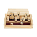 The Mini 9 Number Shut The Box Game features tiles numbered 1 to 9, with numbers 1, 4, 6, 7, and 9 flipped down and two dice showing a roll of 2 and 5—all set in a wooden tray lined with red felt. This compact game is the perfect travel-sized dice game for hours of fun wherever you go.