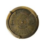The Antiqued Solid Brass Compass is a round 100-year calendar in solid brass, engraved with numbers, months, and days. It has an anchor on the left, sailing ship on the right, and rotating parts to set years (2000–2099) and months for date calculation.