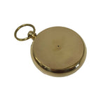 A closed, round Solid Polished Brass Pocket Compass with a smooth, plain cover and a looped ring at the top rests on a white background, creating an elegant decorative accent.