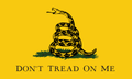 The Gadsden "Don't Tread on Me" Flag Sticker features a coiled rattlesnake with its tongue out on green grass, set against a yellow background, with bold black text beneath the snake reading "Don't Tread on Me.